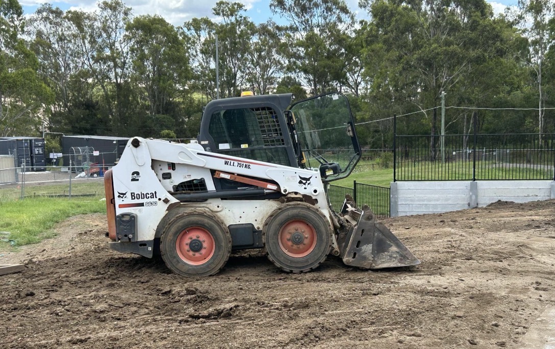 Bobcat S630 skid-steer loader completing site preparation
